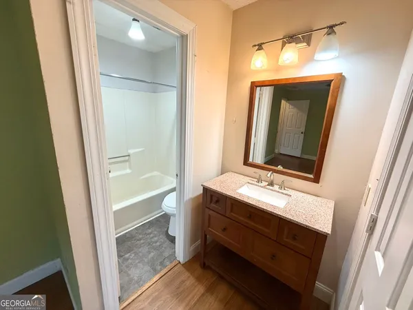 a bathroom with a sink a mirror and a bathtub