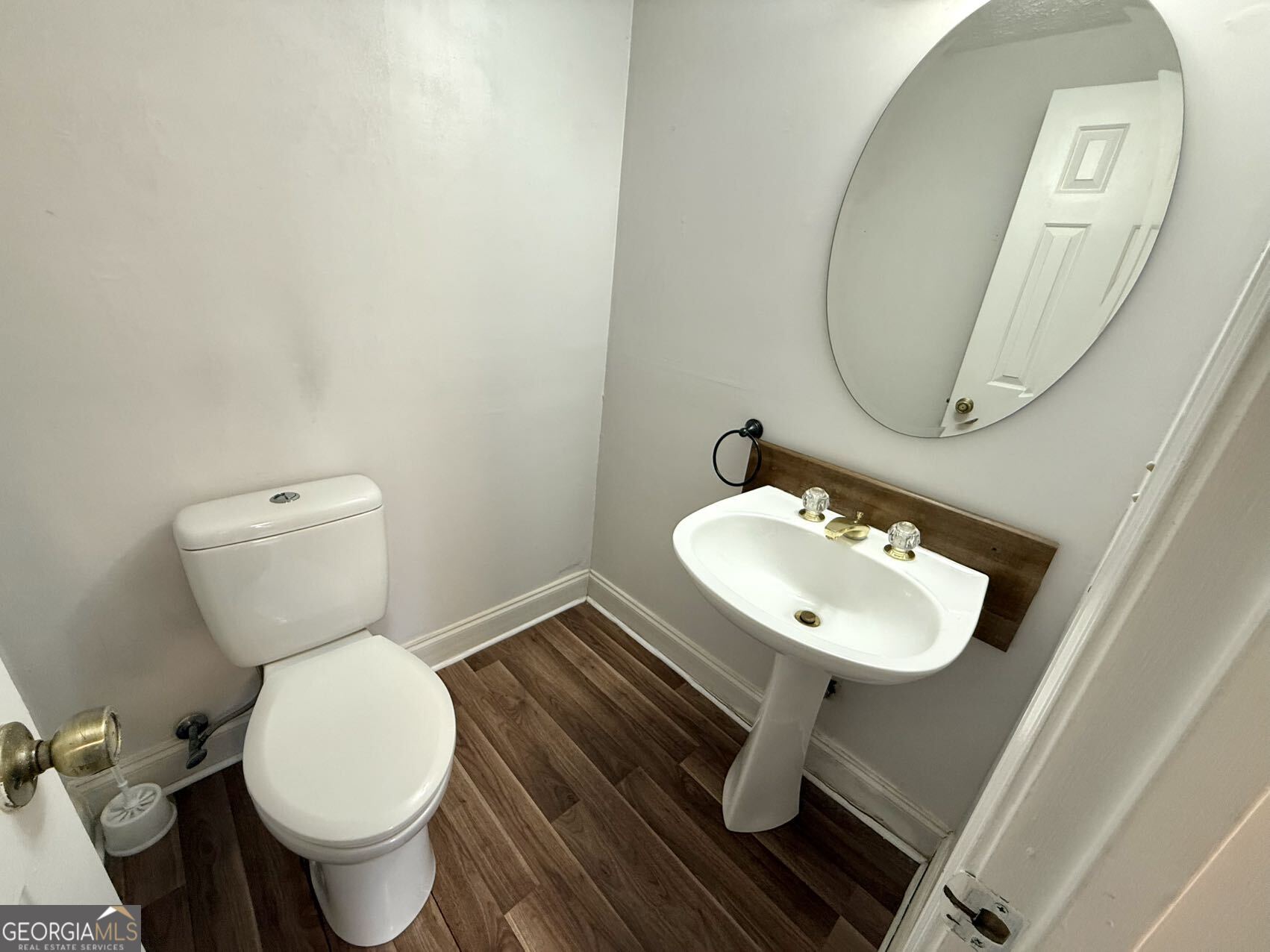 1220 Kennesaw Trace Court Kennesaw, GA 30144 - Photo 4 of 21 a bathroom with a toilet a sink and a mirror