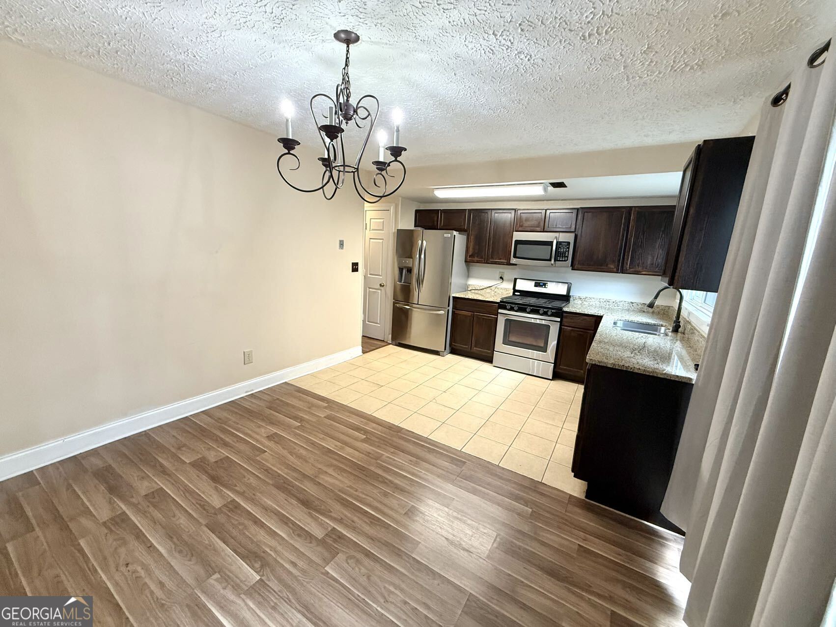 1220 Kennesaw Trace Court Kennesaw, GA 30144 - Photo 9 of 21 a kitchen with a stove and wooden floor