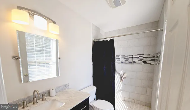 a bathroom with a shower and a sink