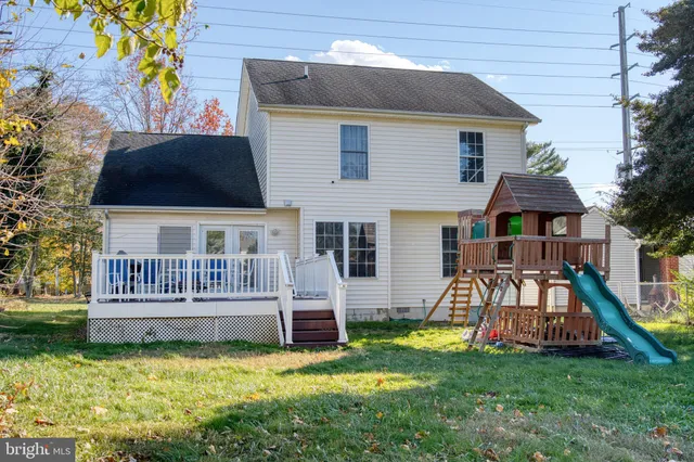 a view of a house with a yard and deck
