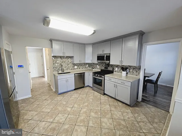a kitchen with a stove a sink and a refrigerator