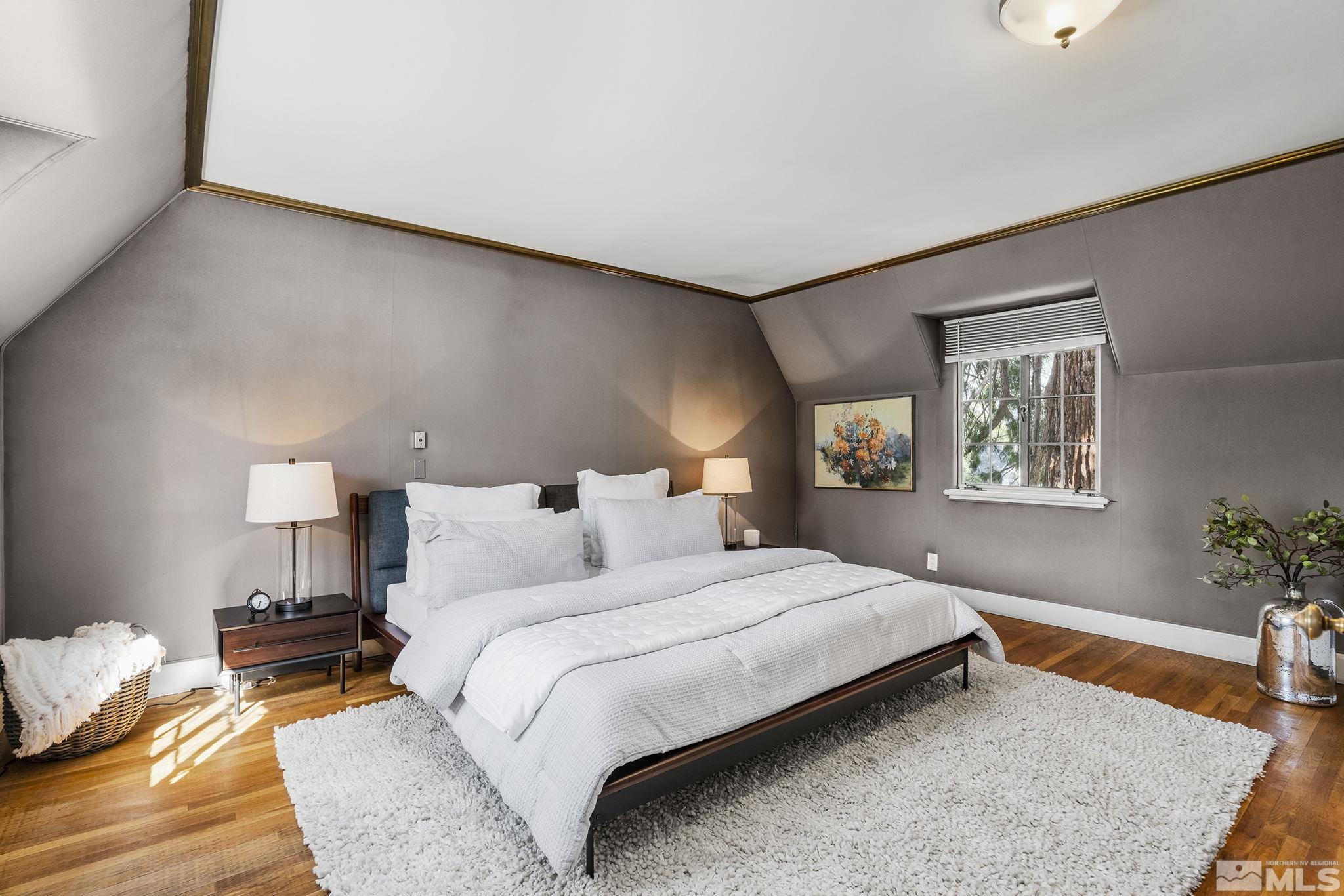 751 Marsh Avenue Reno, NV 89509 - Photo 23 of 39 a bedroom with a bed lamp and a potted plant