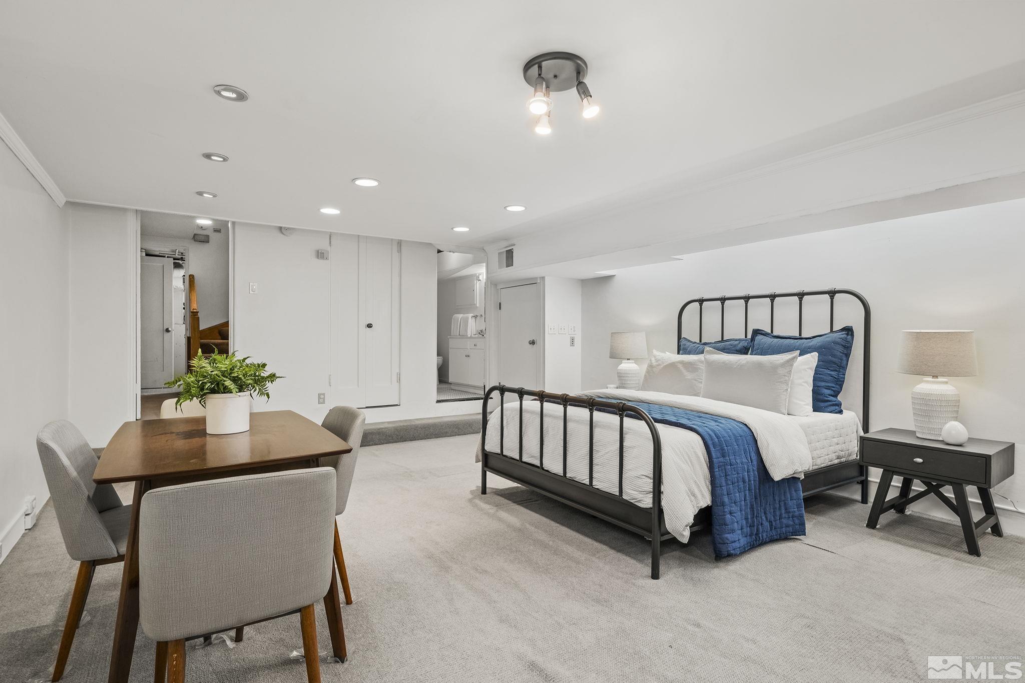 751 Marsh Avenue Reno, NV 89509 - Photo 28 of 39 a spacious bedroom with a bed and a table