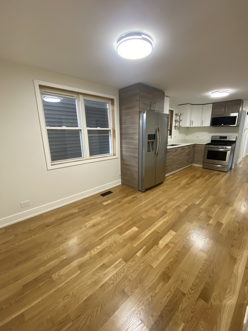 3270 North Elston Avenue, Unit 1 Chicago, IL 60618 - Photo 11 of 13 a view of an empty room with a kitchen