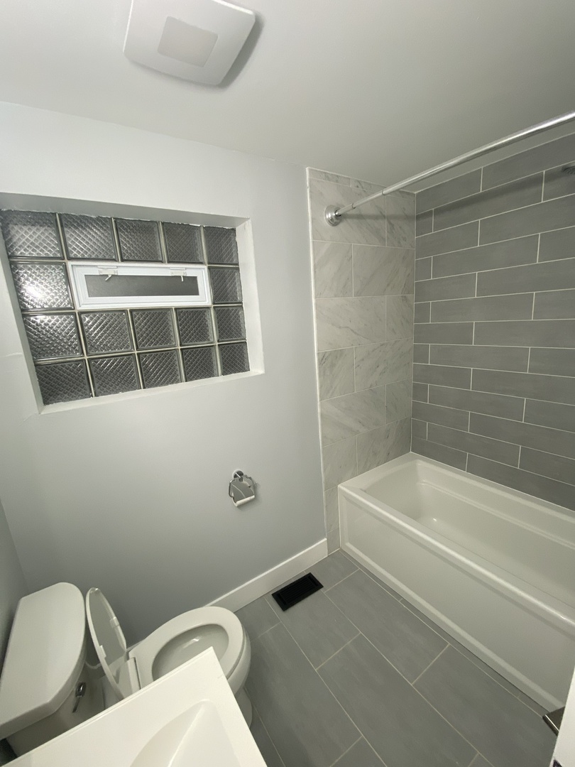 3270 North Elston Avenue, Unit 1 Chicago, IL 60618 - Photo 5 of 13 a bathroom with a toilet and a bath tub