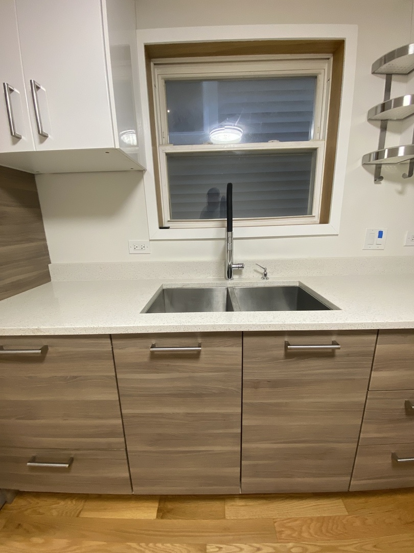 3270 North Elston Avenue, Unit 1 Chicago, IL 60618 - Photo 9 of 13 a bathroom with a sink and a mirror