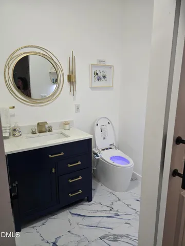 a bathroom with a sink a mirror and toilet
