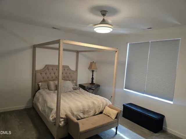 a bedroom with a bed and a lamp
