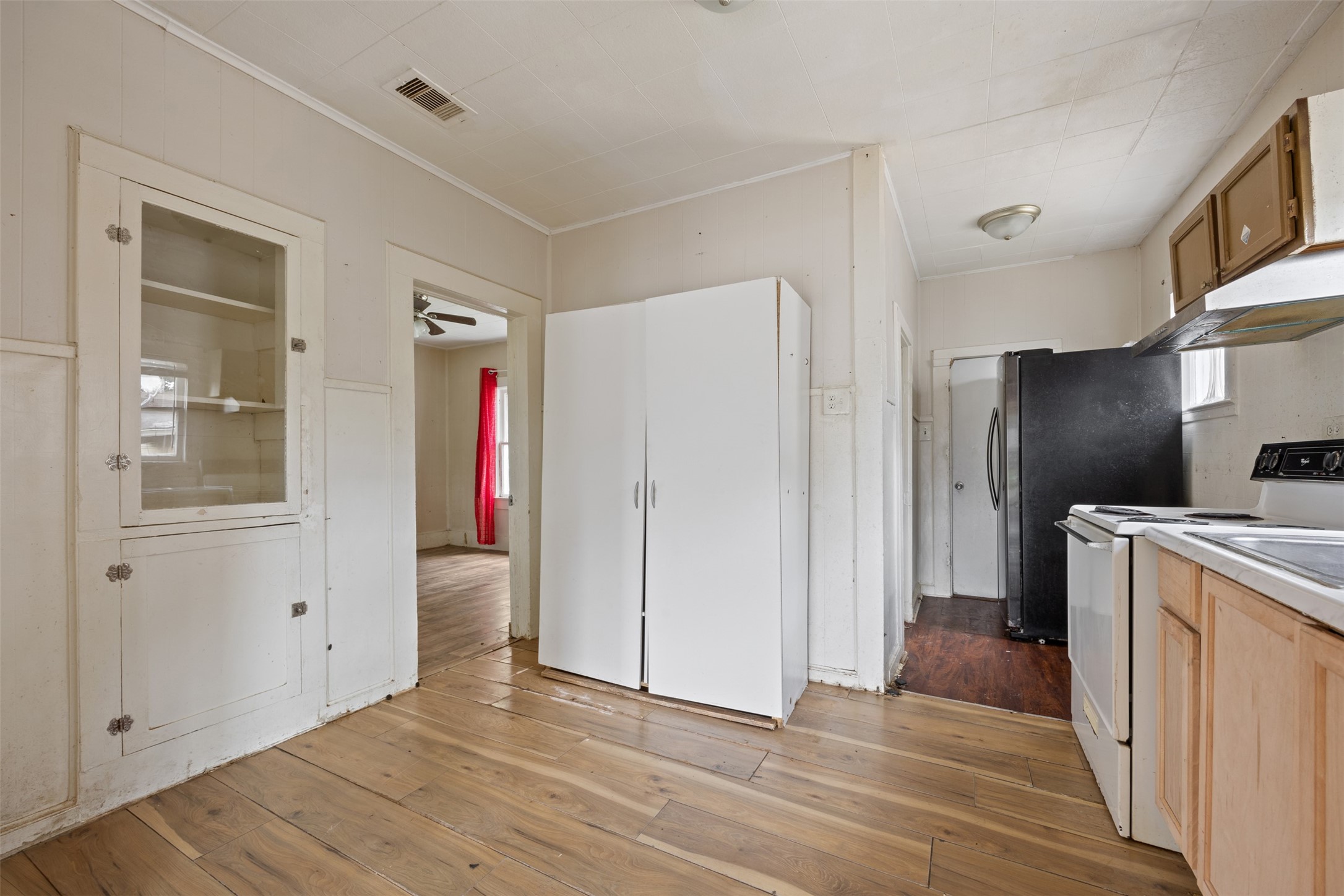 1410 8th Street Rosenberg, TX 77471 - Photo 13 of 25 a view of a kitchen with a sink and refrigerator