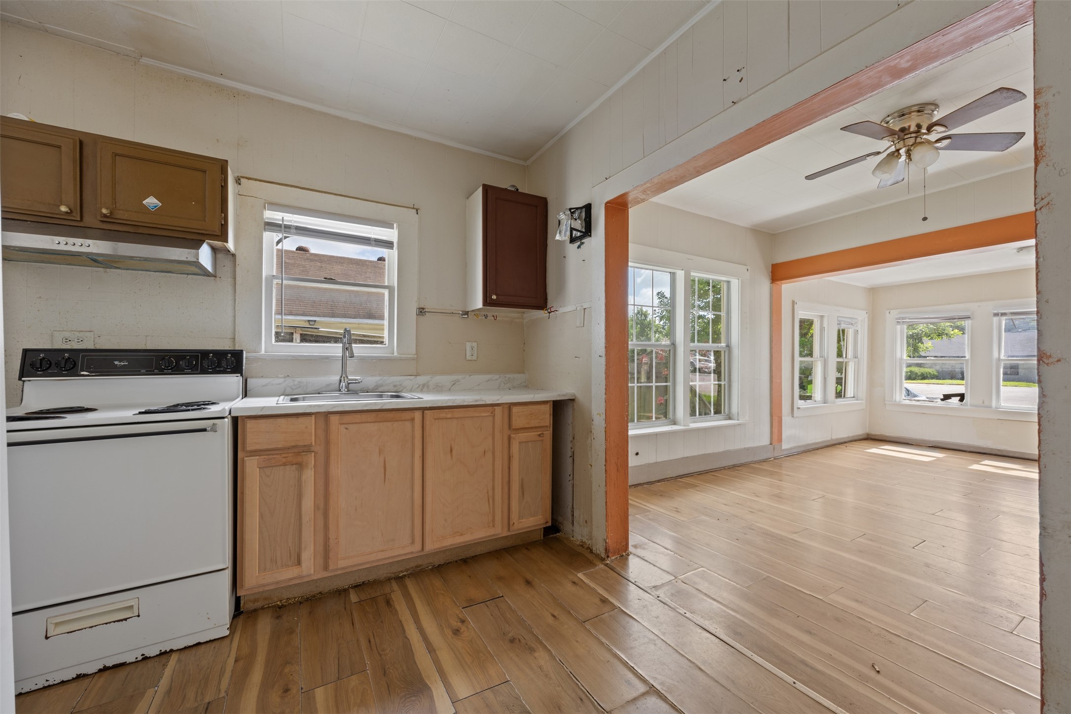 1410 8th Street Rosenberg, TX 77471 - Photo 14 of 25 a kitchen with granite countertop a stove a sink and a microwave