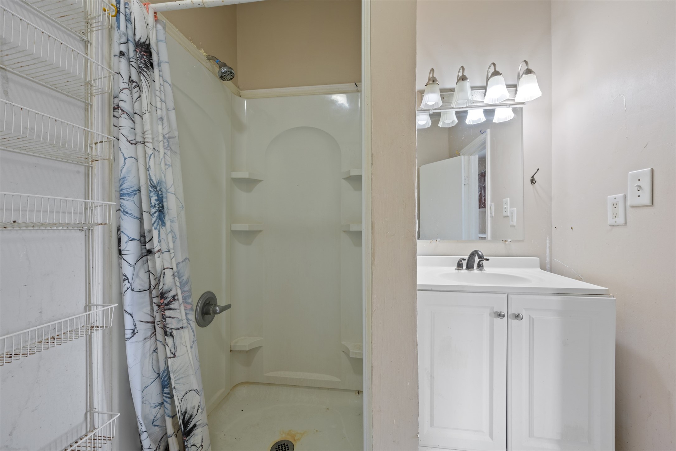 1410 8th Street Rosenberg, TX 77471 - Photo 16 of 25 a bathroom with a granite countertop sink a toilet and shower