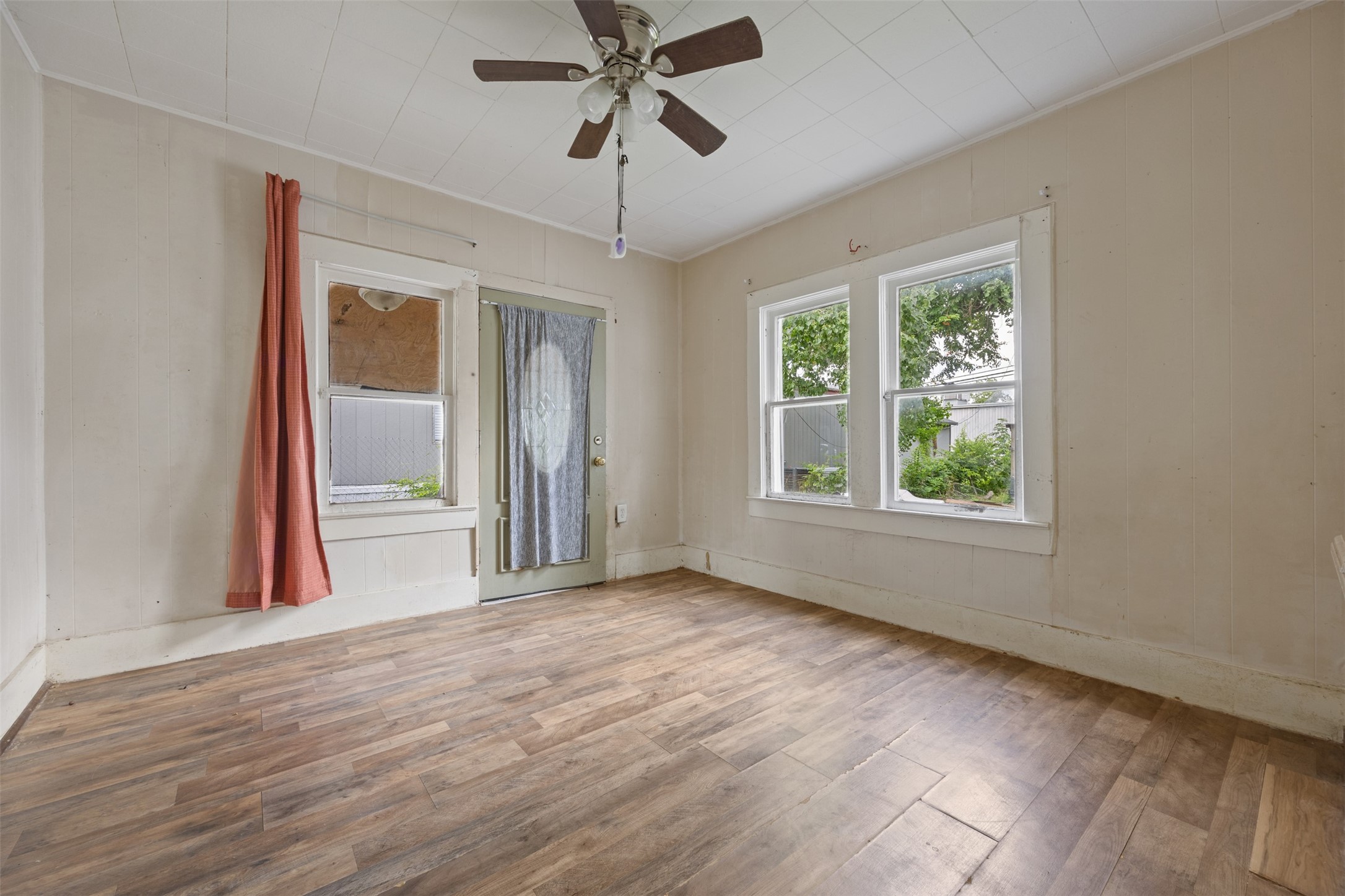 1410 8th Street Rosenberg, TX 77471 - Photo 17 of 25 a view of an empty room with a window and wooden floor