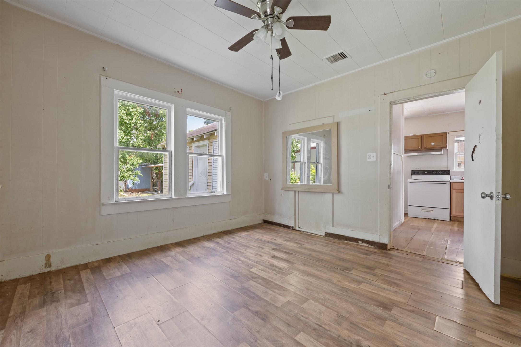 1410 8th Street Rosenberg, TX 77471 - Photo 18 of 25 a view of an empty room with a window and wooden floor