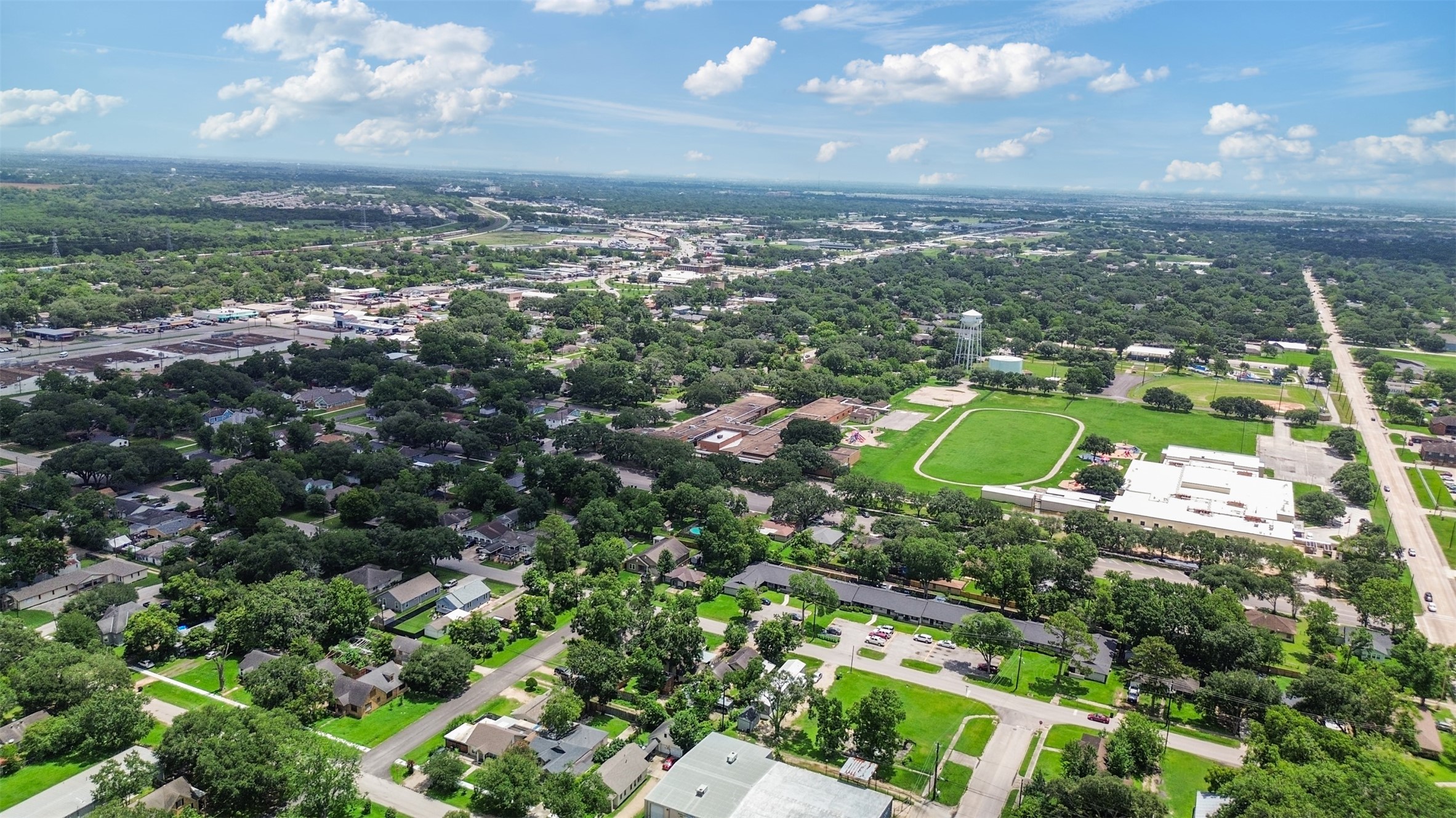 1410 8th Street Rosenberg, TX 77471 - Photo 24 of 25 an aerial view of residential houses with outdoor space and trees