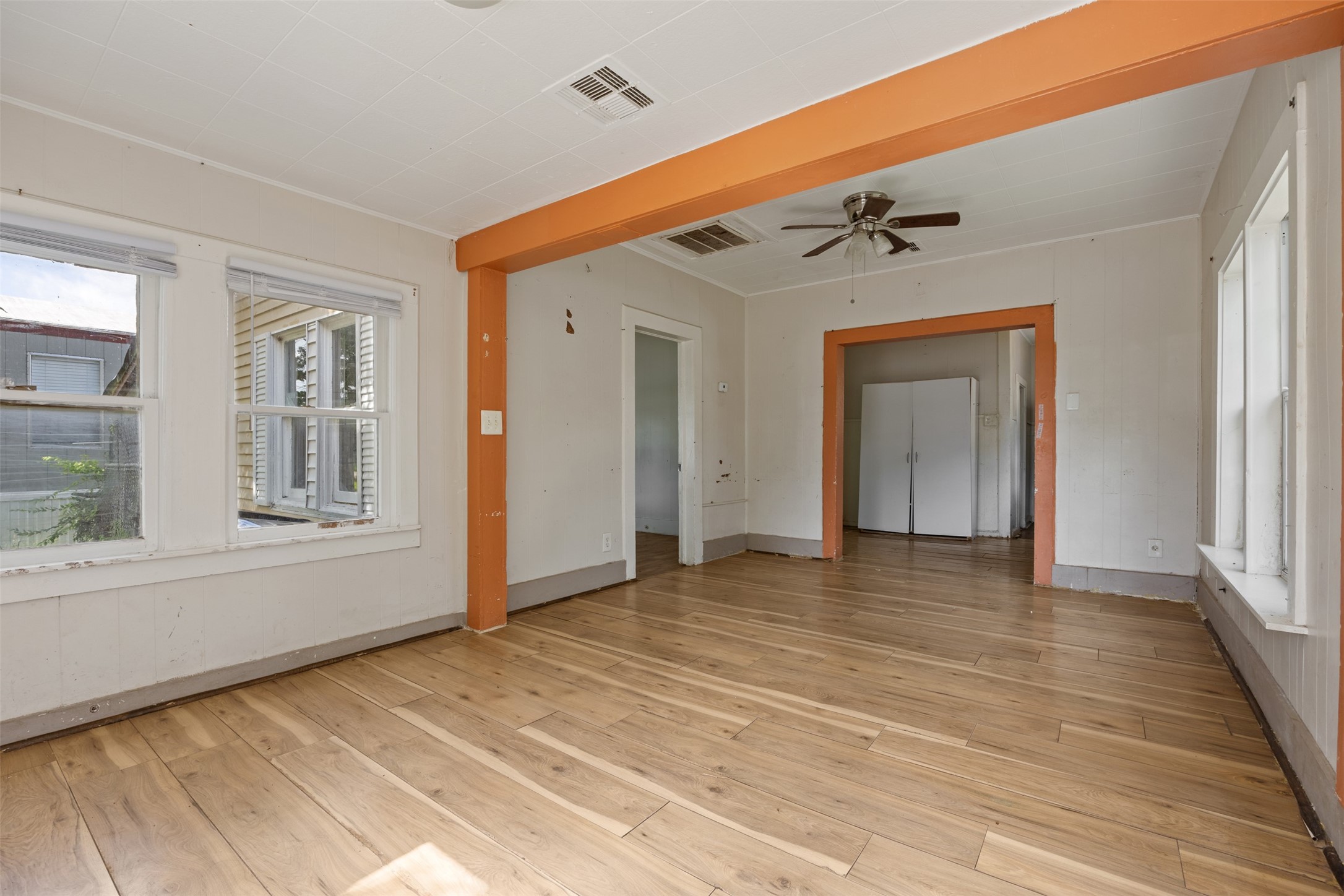 1410 8th Street Rosenberg, TX 77471 - Photo 5 of 25 a view of an empty room with wooden floor and a window