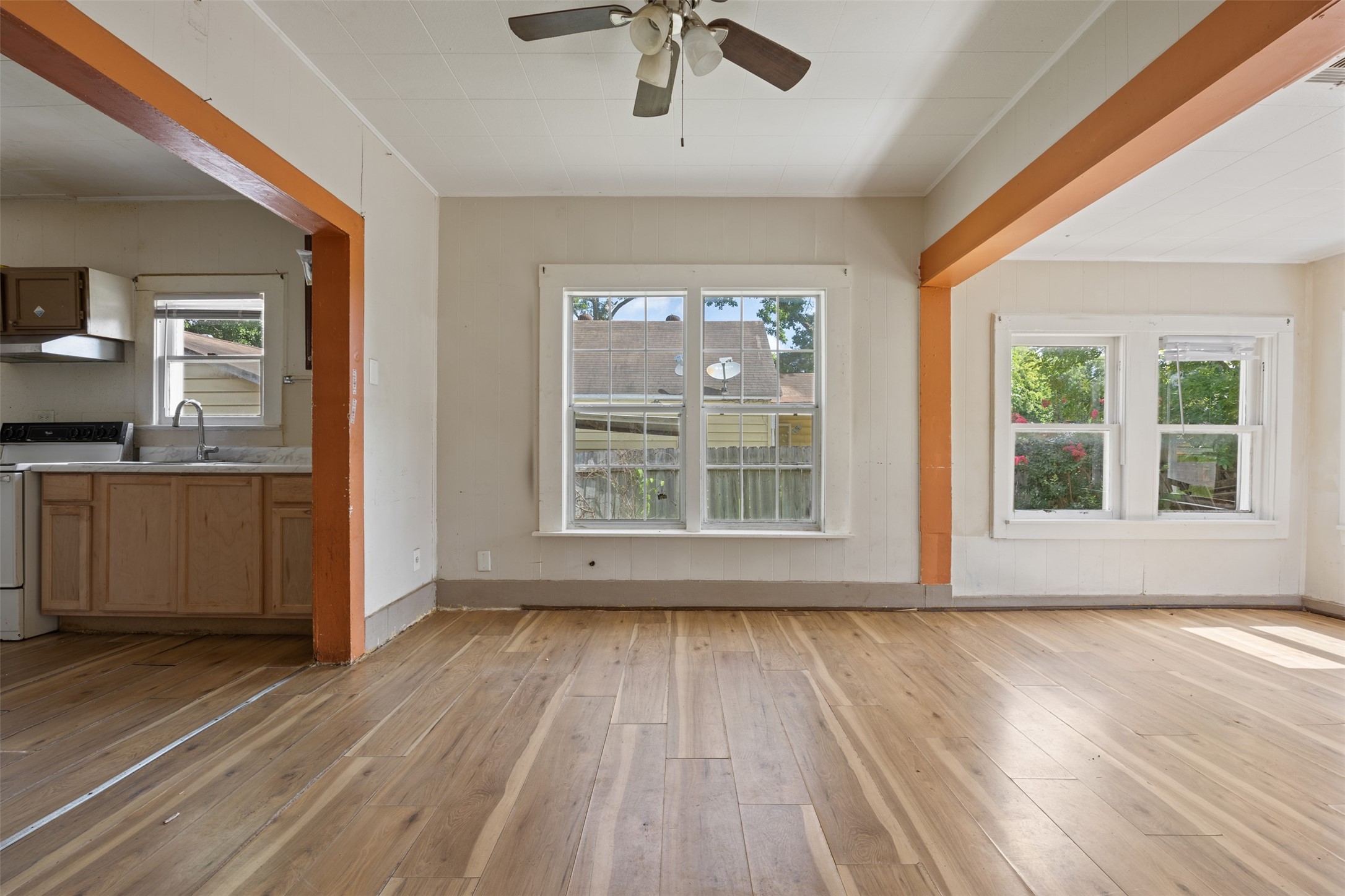 1410 8th Street Rosenberg, TX 77471 - Photo 6 of 25 a view of an empty room with a window and wooden floor