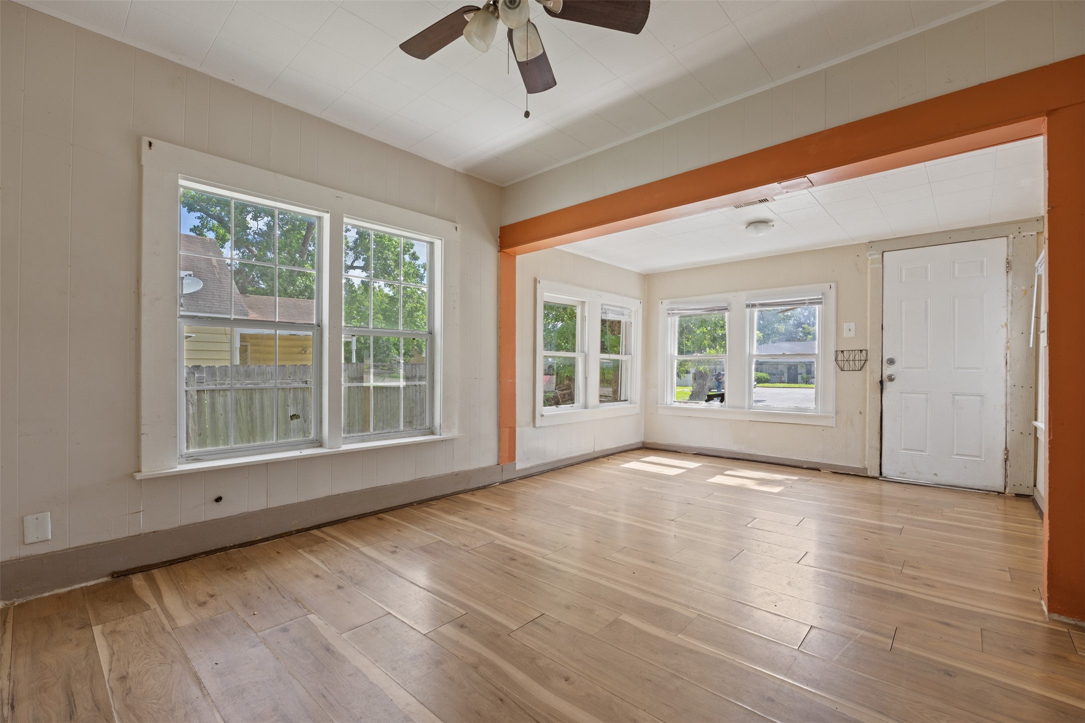 1410 8th Street Rosenberg, TX 77471 - Photo 7 of 25 a view of an empty room with a window and wooden floor