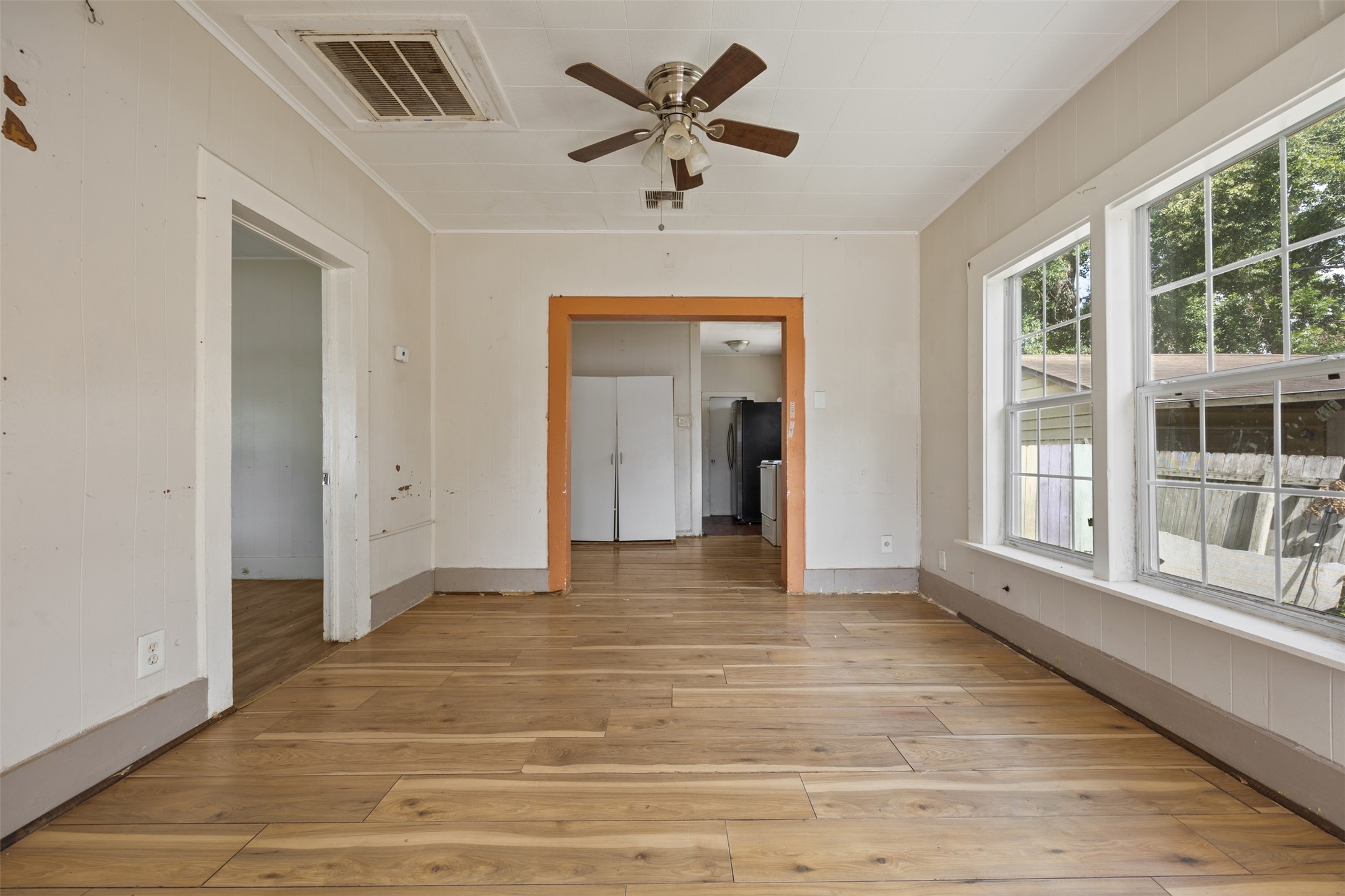 1410 8th Street Rosenberg, TX 77471 - Photo 9 of 25 a view of an empty room with a window and a kitchen