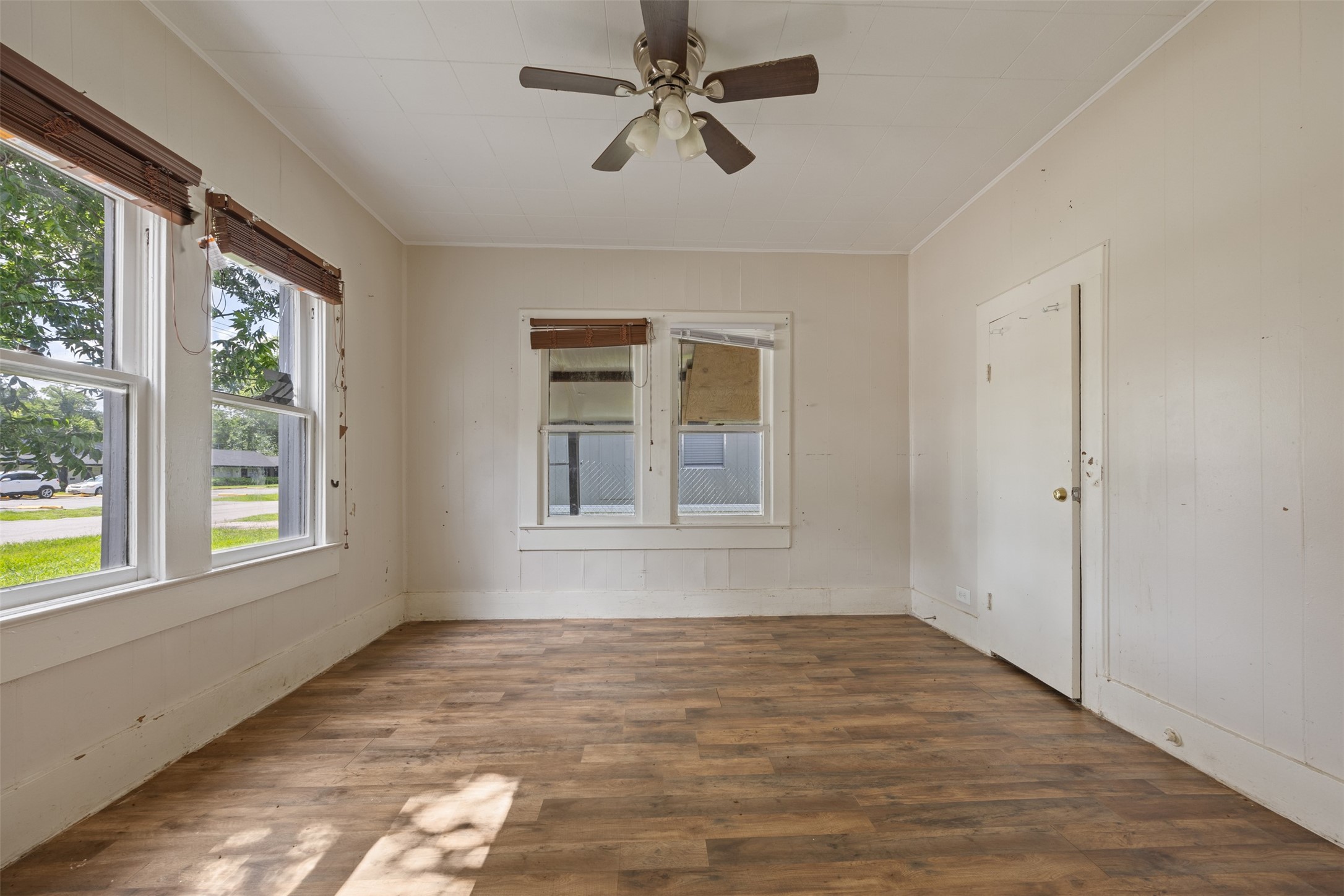 1410 8th Street Rosenberg, TX 77471 - Photo 10 of 25 a view of an empty room with a window and wooden floor