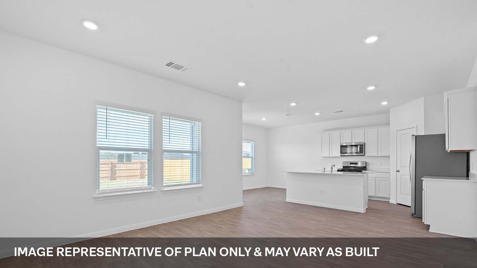 275 Mountain Pea Road Kyle, TX 78640 - Photo 2 of 22 a view of kitchen with kitchen island granite countertop a stove top oven a sink and a refrigerator