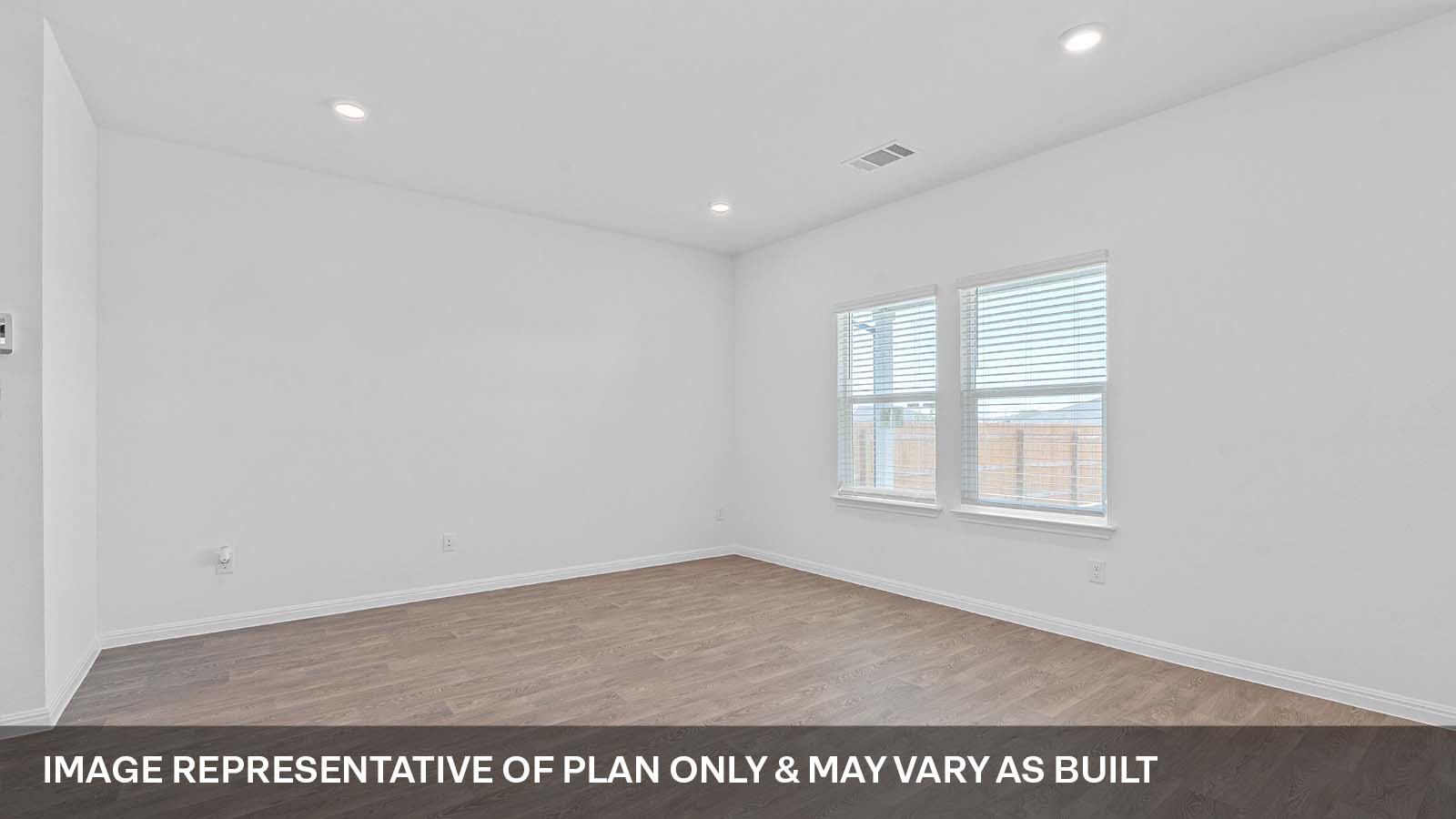 275 Mountain Pea Road Kyle, TX 78640 - Photo 4 of 22 an empty room with wooden floor and windows