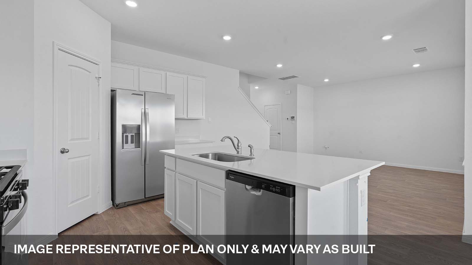 275 Mountain Pea Road Kyle, TX 78640 - Photo 8 of 22 a kitchen with a sink a refrigerator and wooden cabinets