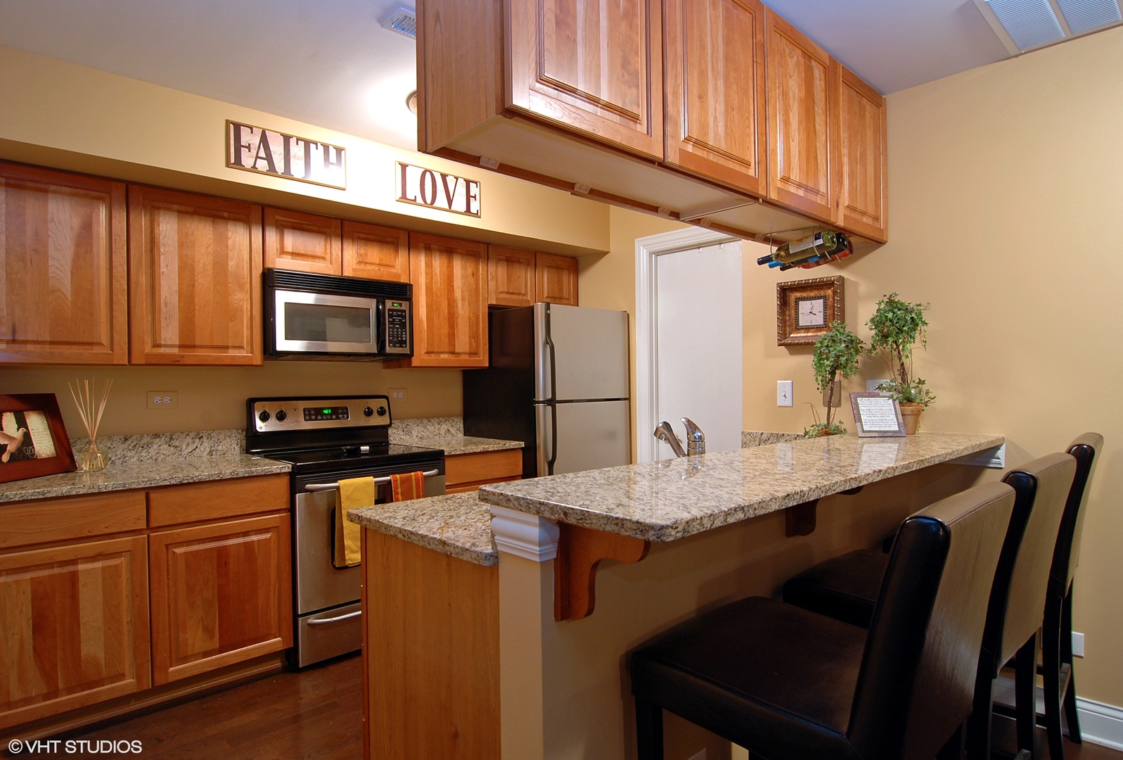 19 Foxcroft Road, Unit 219 Naperville, IL 60565 - Photo 4 of 14 a kitchen with stainless steel appliances granite countertop a stove top oven a sink dishwasher and cabinets with wooden floor