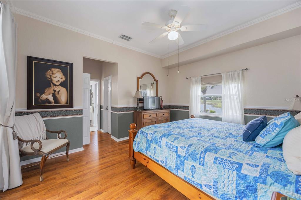 48 Bunker Road Rotonda West, FL 33947 - Photo 25 of 59 a bedroom with a bed and a chandelier