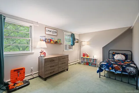 a bedroom with a bed and a lamp