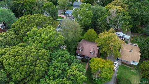 an aerial view of a house with a yard and lake view