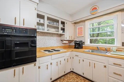 a kitchen with stainless steel appliances a stove a sink and a microwave