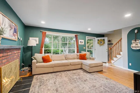a living room with furniture and a floor to ceiling window