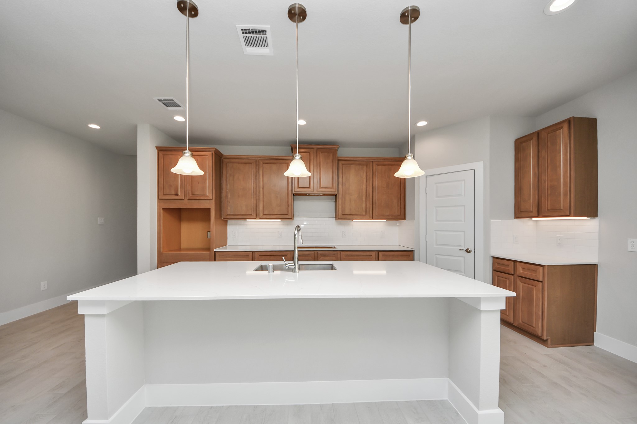 3102 Native Spg Drive Spring, TX 77373 - Photo 10 of 40 The kitchen is a culinary haven, featuring granite countertops, a tile backsplash, stainless steel appliances, 42” upper cabinets, and undercabinet lighting. Sample photo of completed home with similar floor plan. Actual colors and selections may vary.