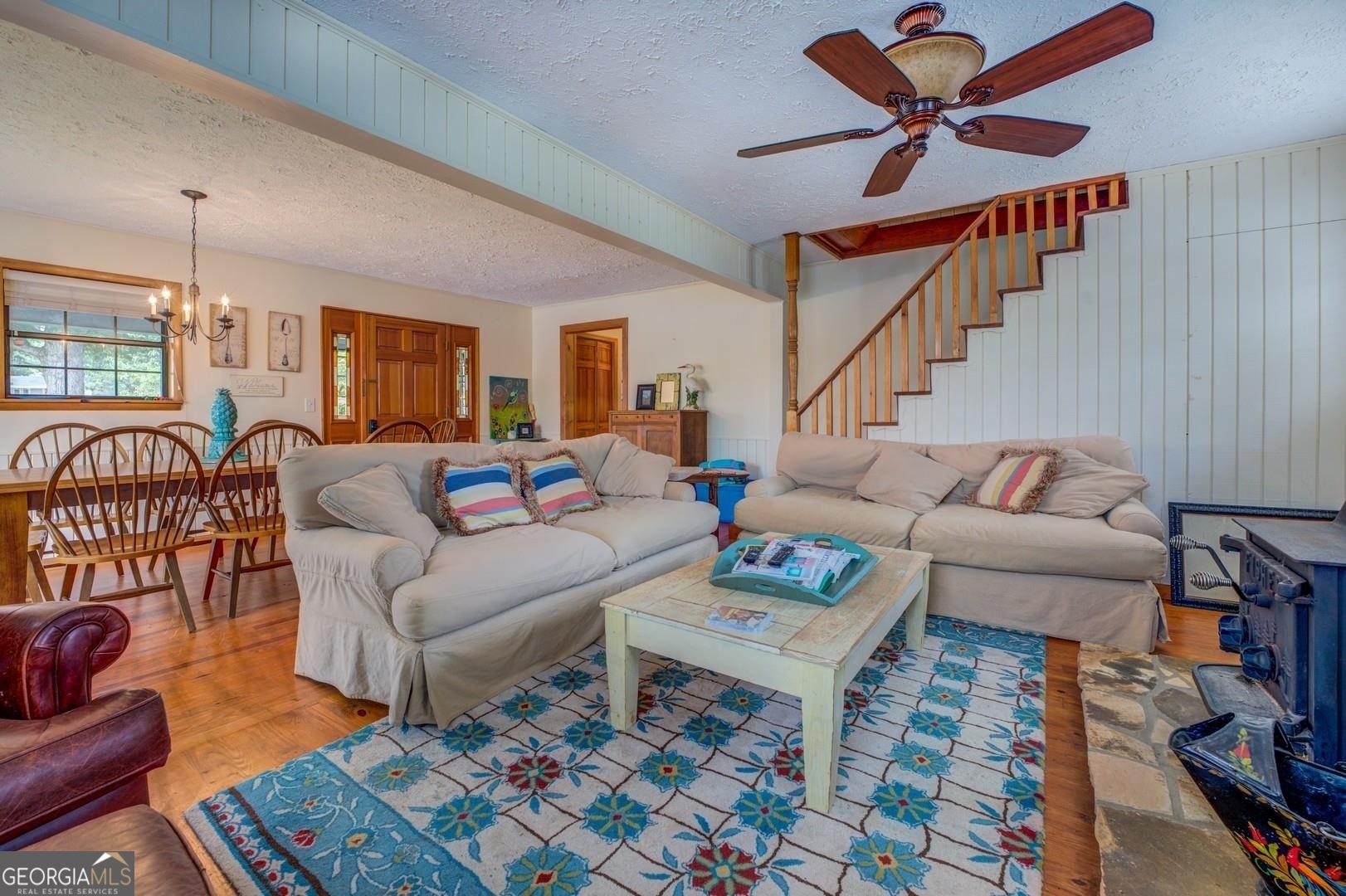 393 Templeton Road Mansfield, GA 30055 - Photo 22 of 54 a living room with furniture a rug and a chandelier