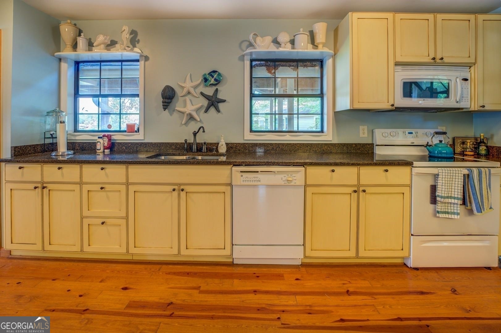 393 Templeton Road Mansfield, GA 30055 - Photo 28 of 54 a kitchen with stainless steel appliances granite countertop a sink and cabinets