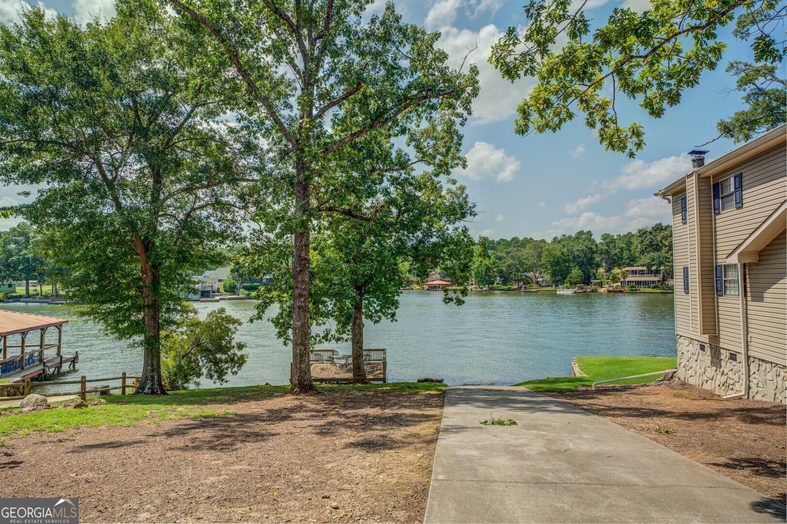 393 Templeton Road Mansfield, GA 30055 - Photo 49 of 54 a view of a lake with a house in the background