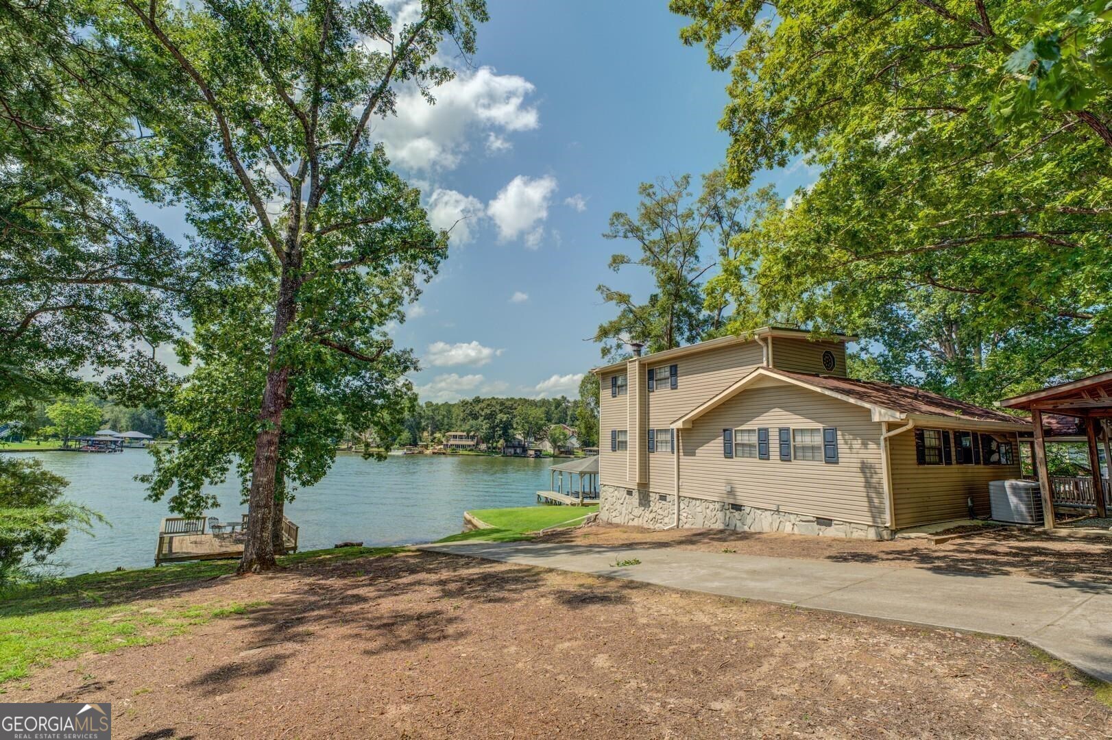 393 Templeton Road Mansfield, GA 30055 - Photo 5 of 54 a front view of a house with a yard and lake view