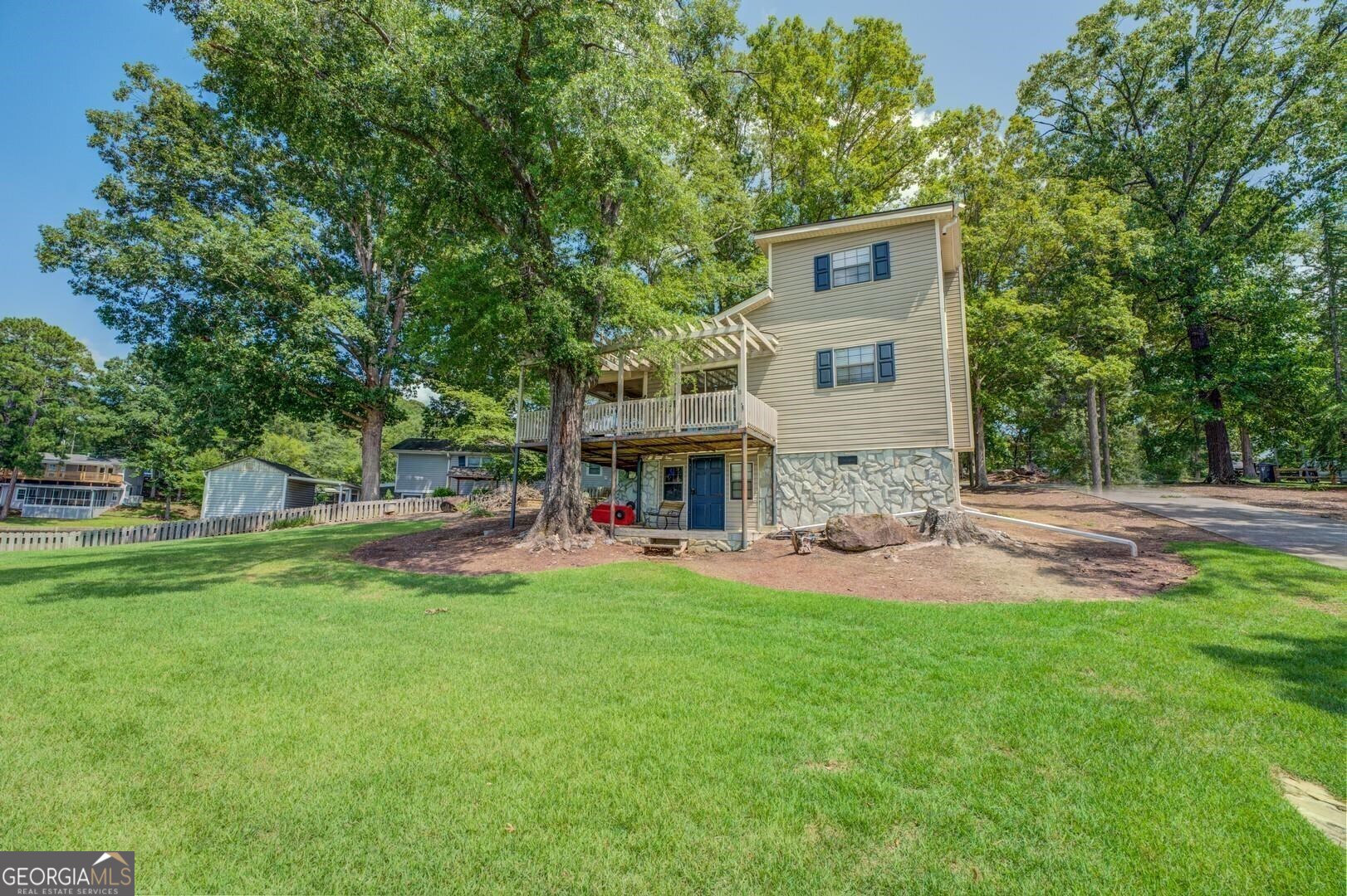 393 Templeton Road Mansfield, GA 30055 - Photo 6 of 54 a view of a house with backyard and a sitting area