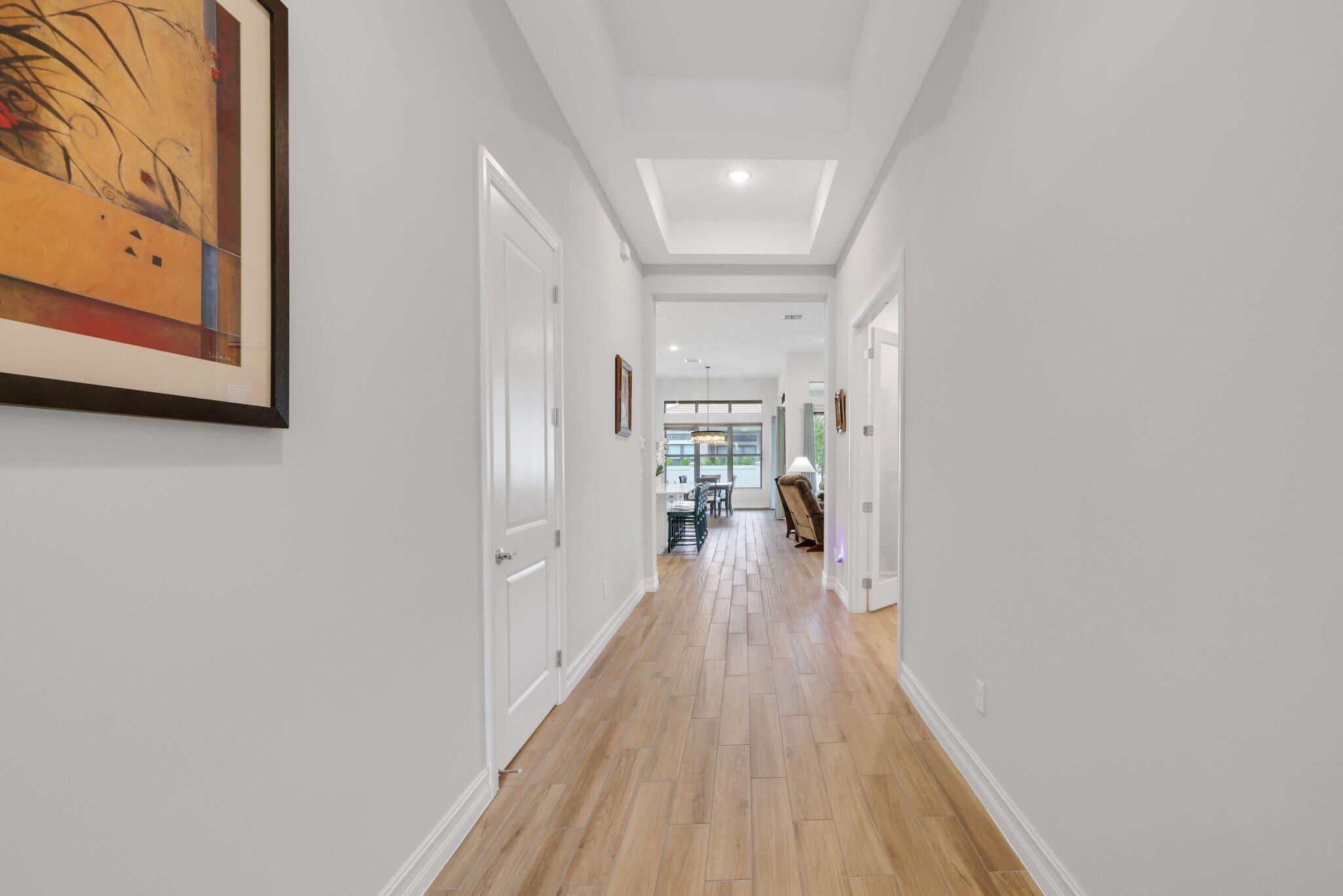 8887 Leon Circle Parkland, FL 33076 - Photo 25 of 54 a view of a hallway with wooden floor