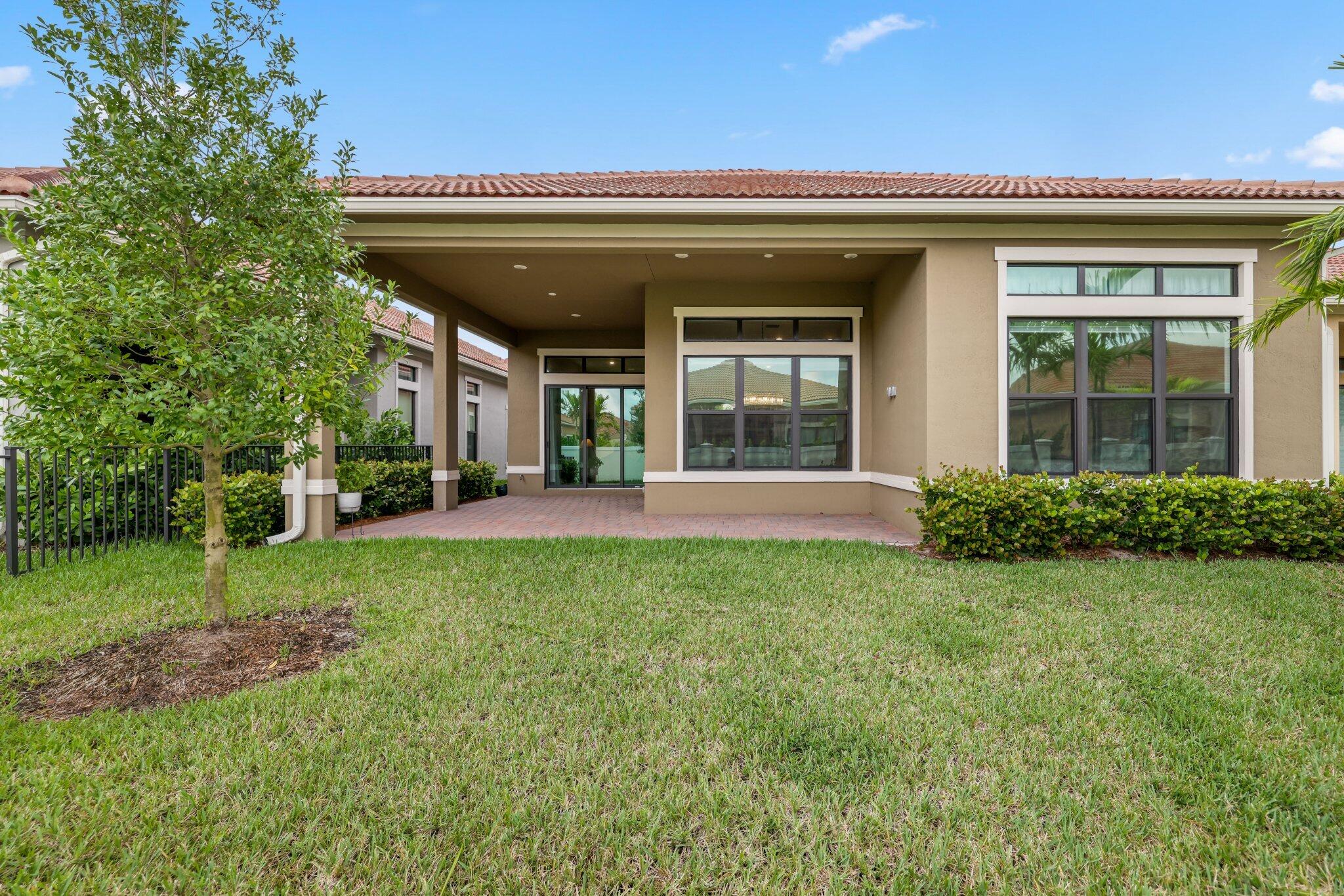 8887 Leon Circle Parkland, FL 33076 - Photo 30 of 54 a view of a house with backyard and porch