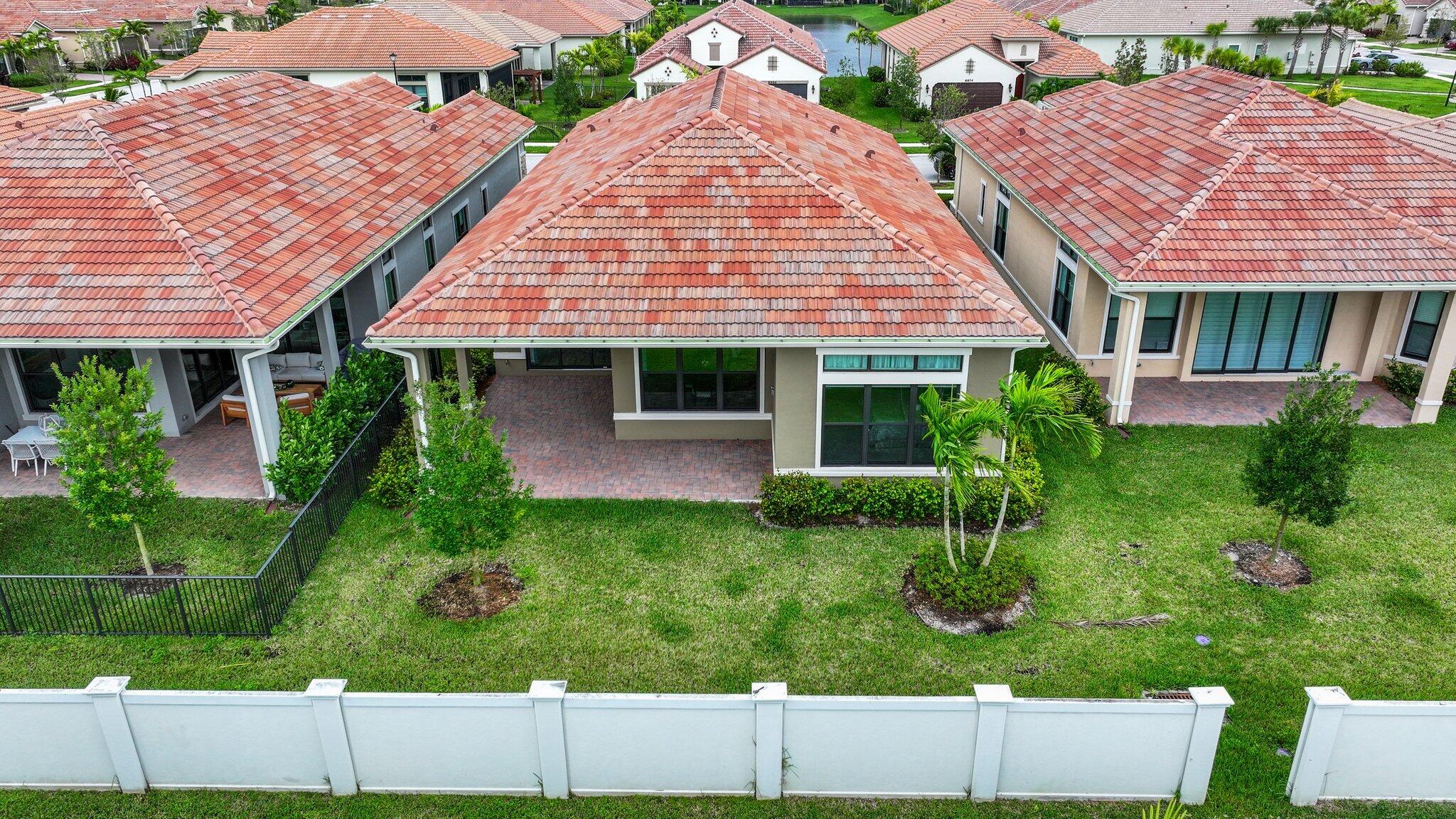 8887 Leon Circle Parkland, FL 33076 - Photo 35 of 54 a front view of a house with a yard and potted plants