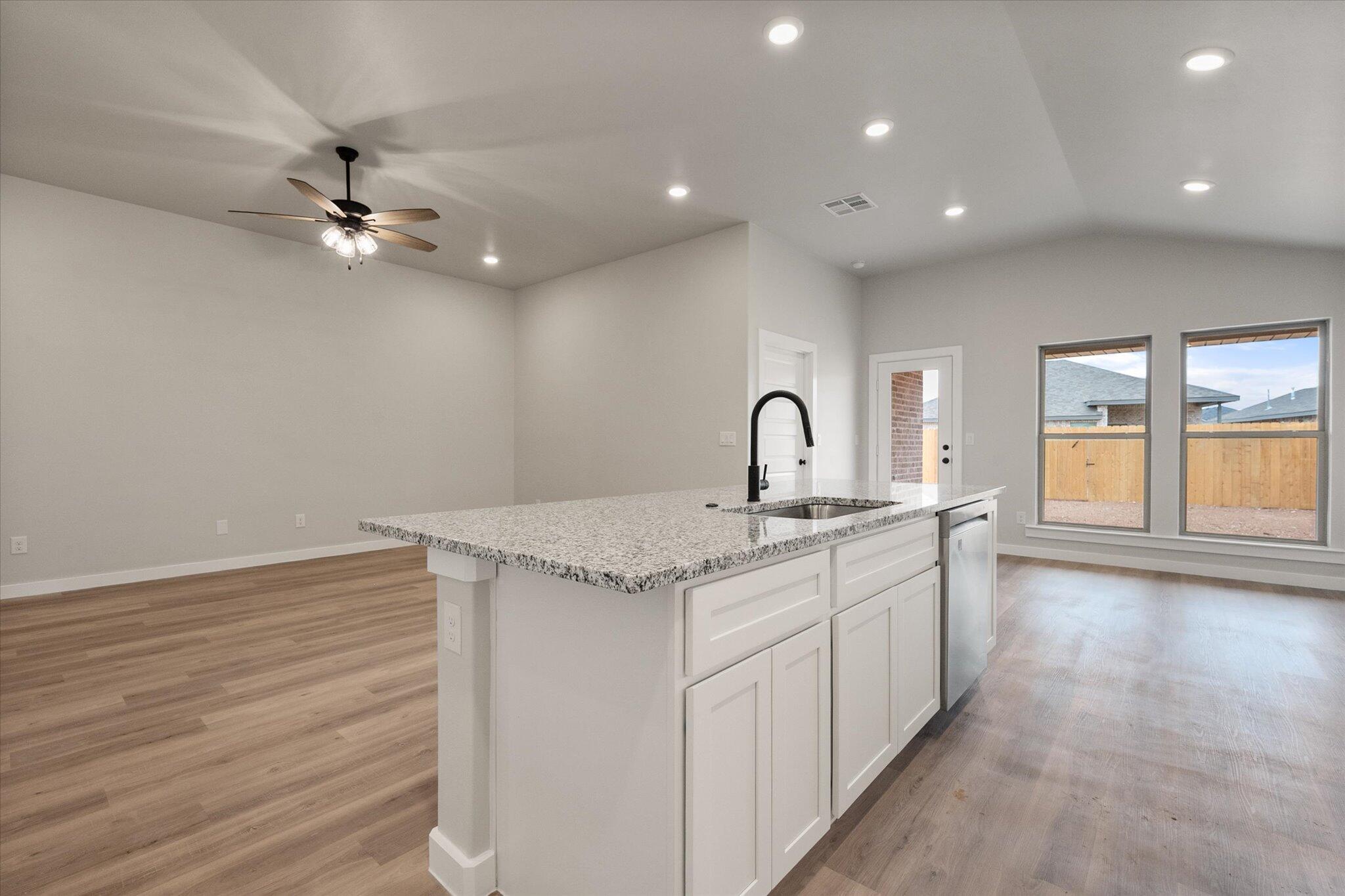 2332 136th Street Lubbock, TX 79423 - Photo 11 of 19 a kitchen with a sink appliances cabinets and a window