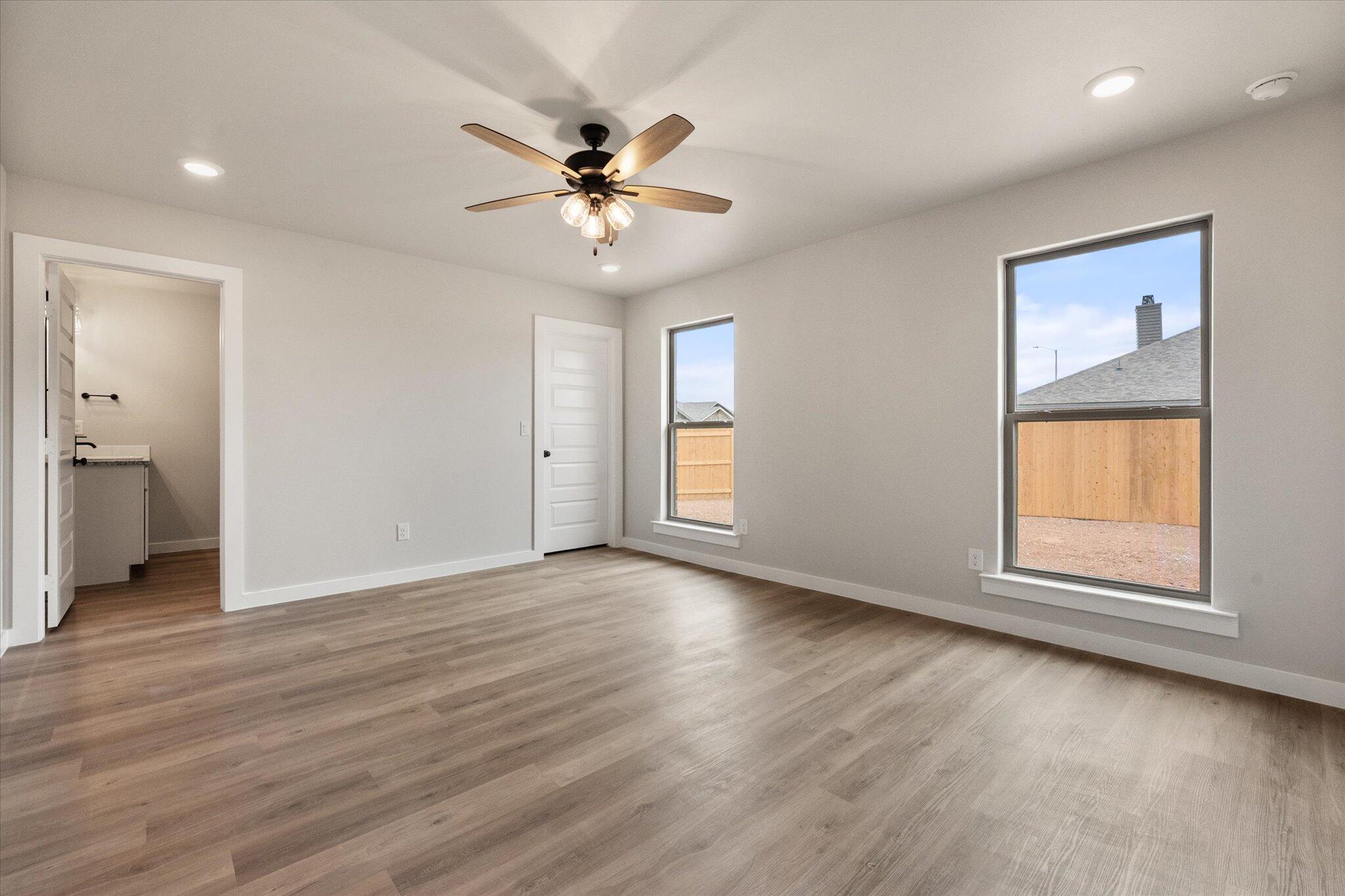 2332 136th Street Lubbock, TX 79423 - Photo 12 of 19 a view of an empty room with a window and wooden floor