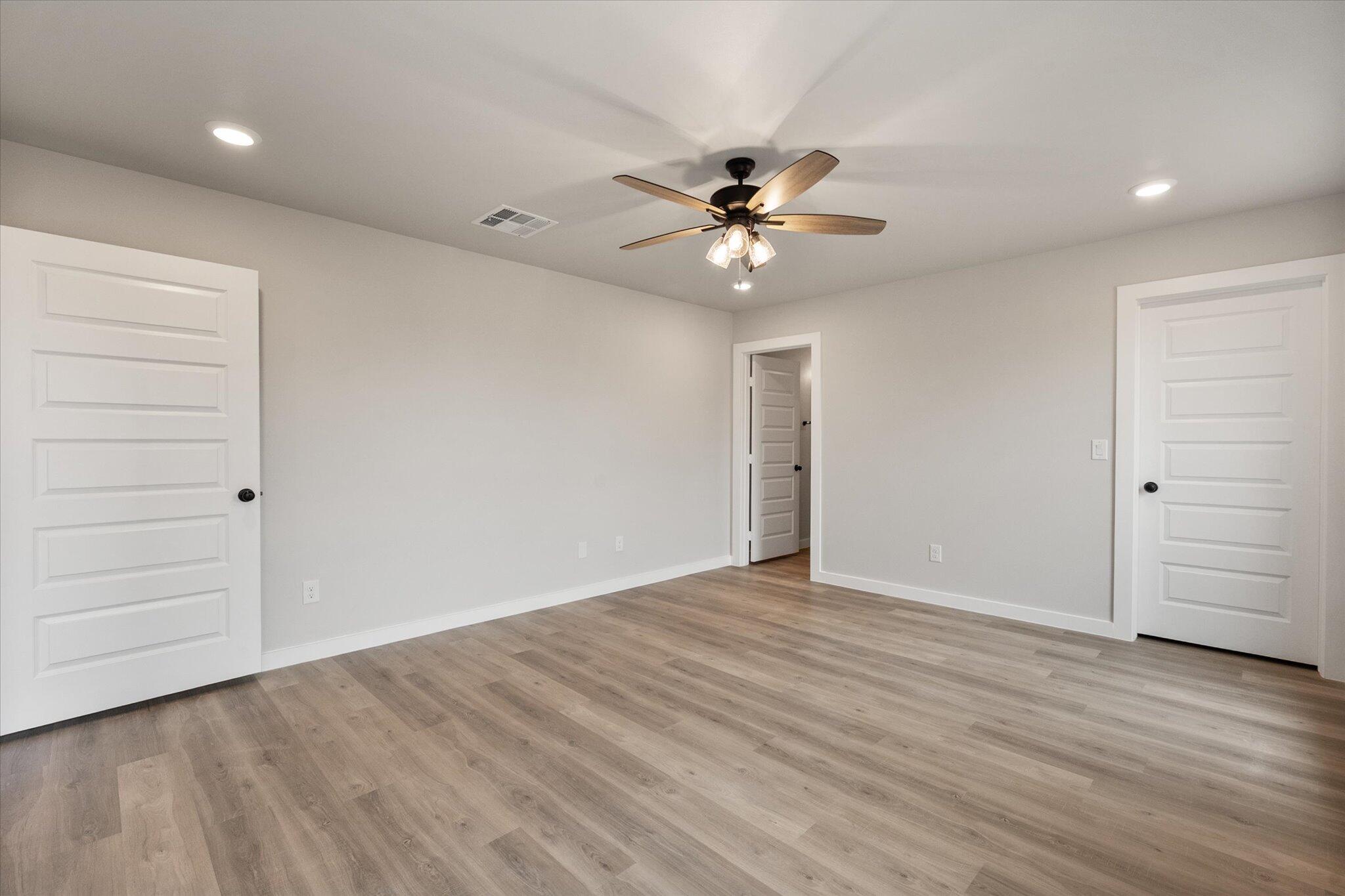 2332 136th Street Lubbock, TX 79423 - Photo 13 of 19 wooden floor in an empty room with a window