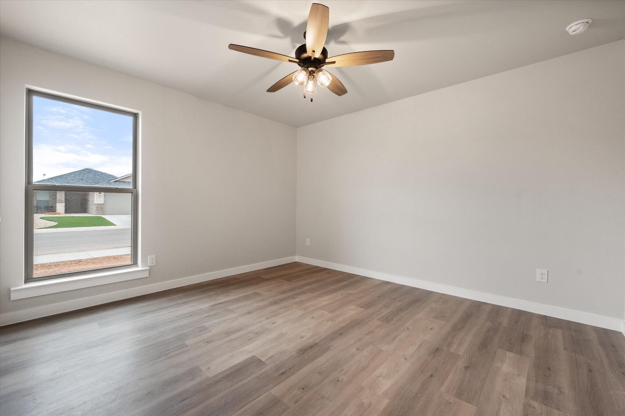2332 136th Street Lubbock, TX 79423 - Photo 16 of 19 an empty room with a window and a ceiling fan
