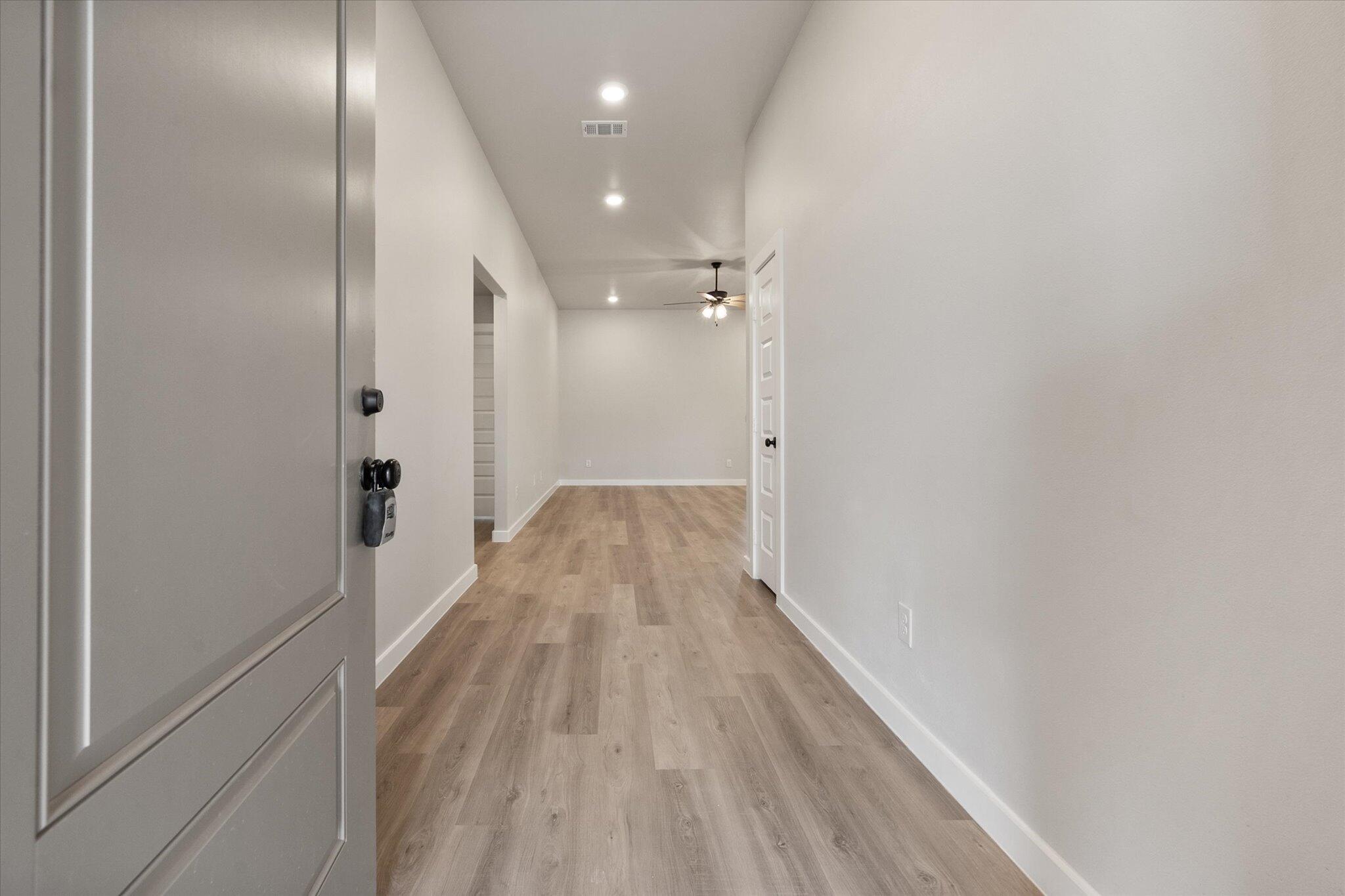 2332 136th Street Lubbock, TX 79423 - Photo 2 of 19 a view of a hallway with wooden floor
