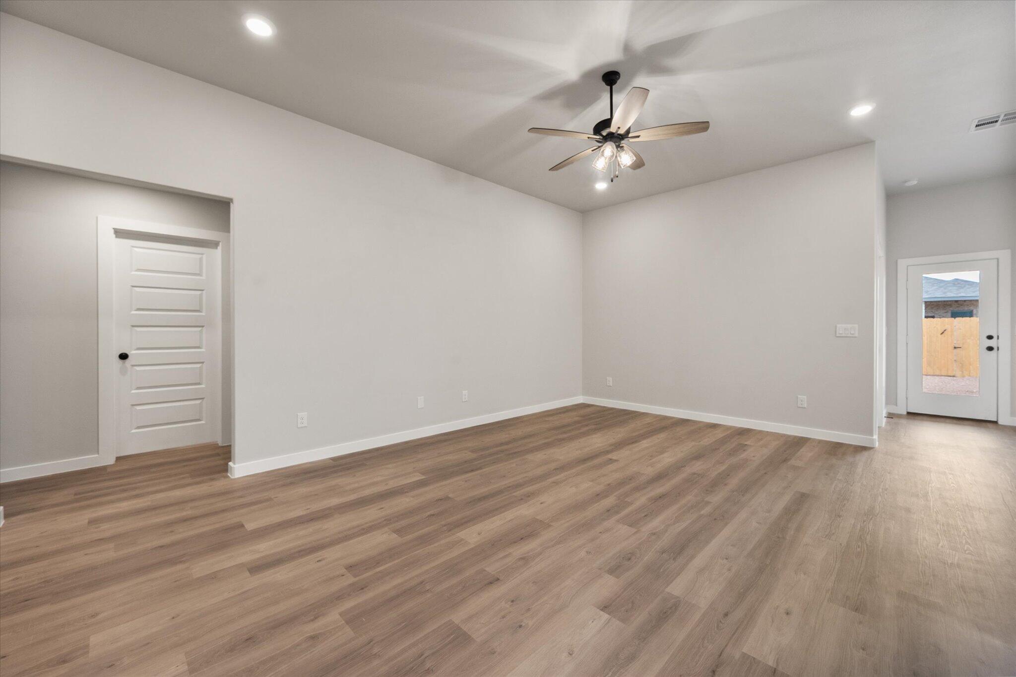 2332 136th Street Lubbock, TX 79423 - Photo 4 of 19 a view of an empty room with wooden floor