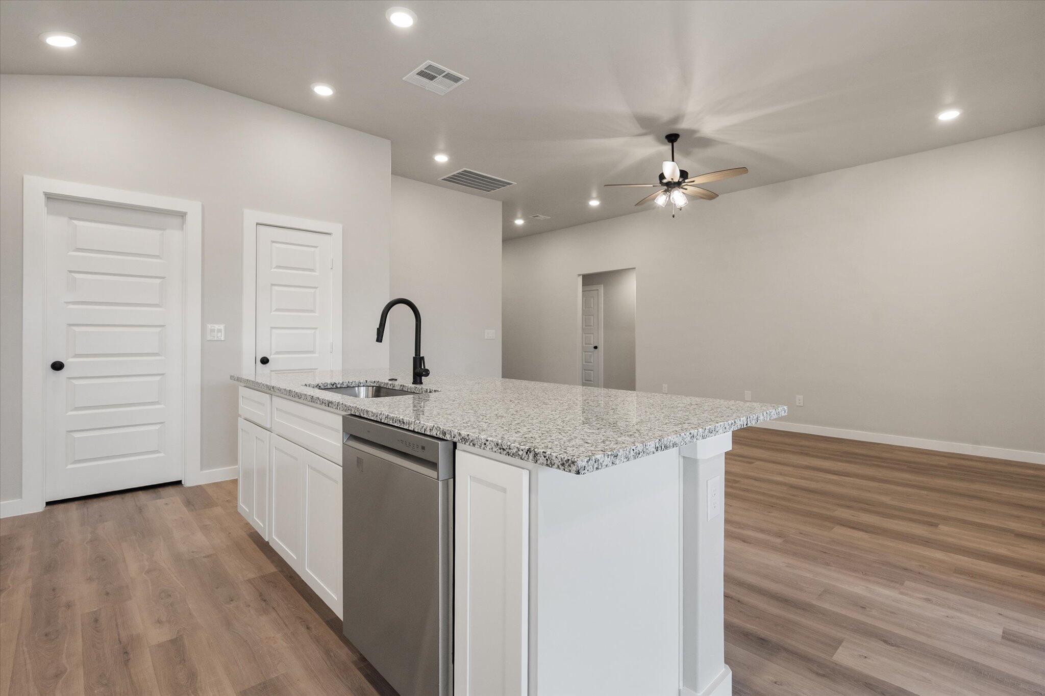 2332 136th Street Lubbock, TX 79423 - Photo 10 of 19 a kitchen with a sink vanity granite and stainless steel appliances