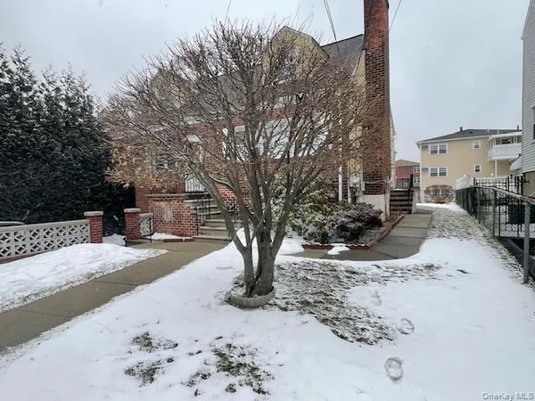 a view of a backyard with snow on the road